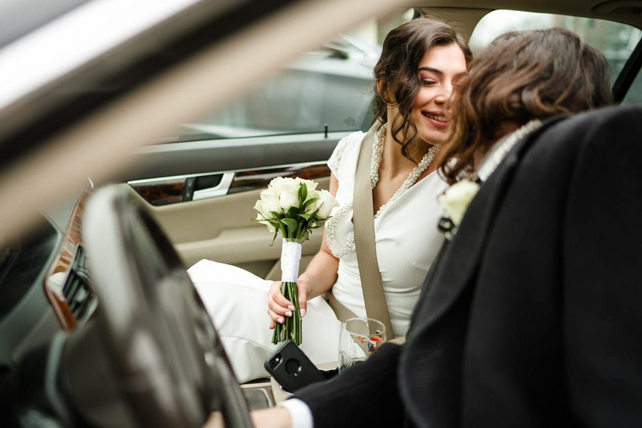 A documentary photograph of a bride and groom kissing in the car after their intimate Worcester Art Museum Wedding 