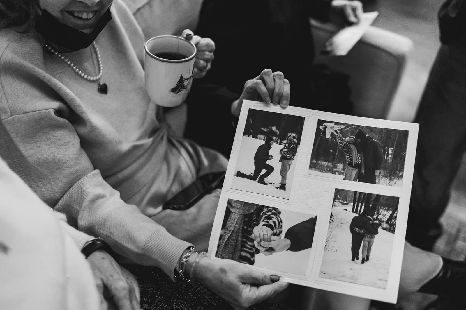 A documentary photograph of guests showing photographs during a in home celebration after their intimate Worcester Art Museum Wedding ceremony
